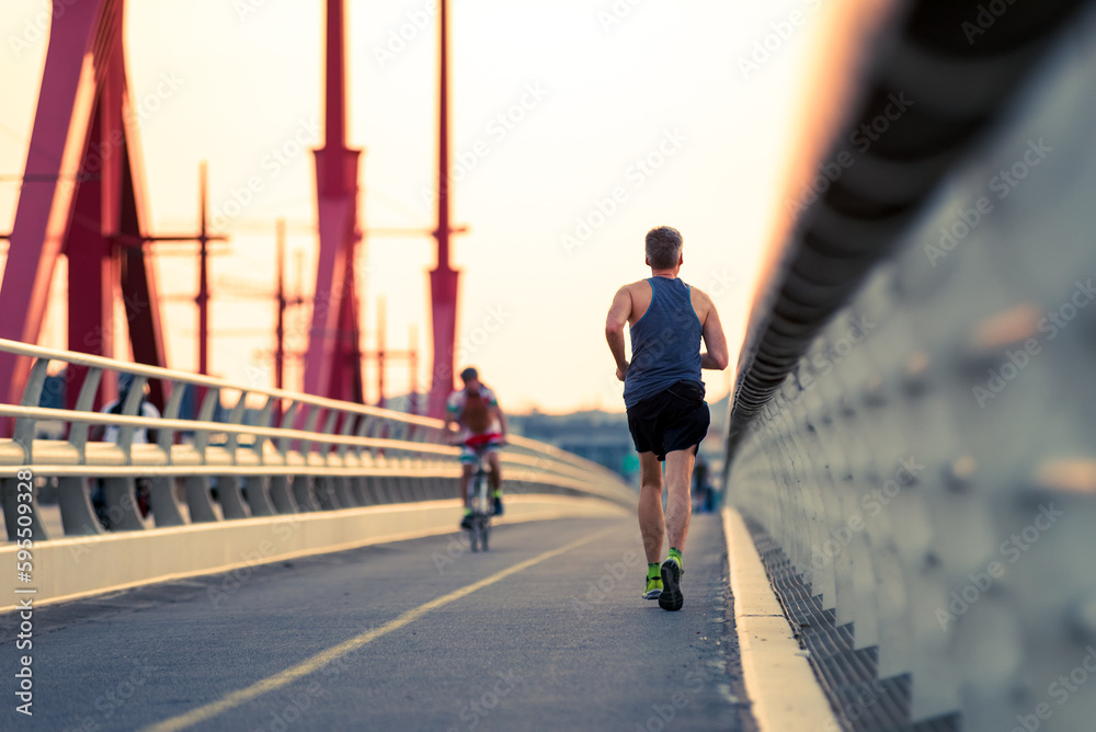 Runner and bicyclist on the bridge