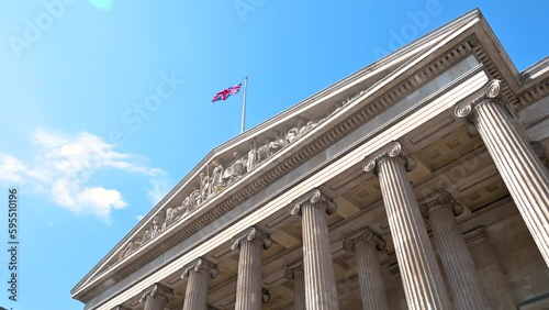 Low angle 4K footage of the entrance of the British Museum with the United Kingdom flag waving in London, England, UK photo