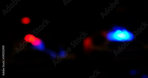defocused video of the sires of a police squad car outside in the night photo