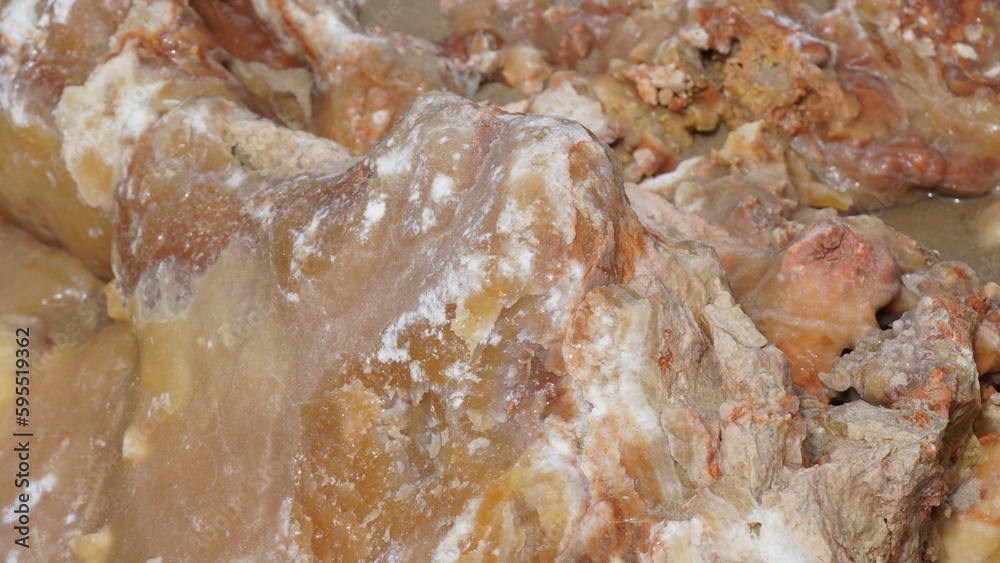 Huge piece of quartz rock in white sand on the Mediterranean sea beach Huge piece of quartz rock in white sand on the Mediterranean sea beach