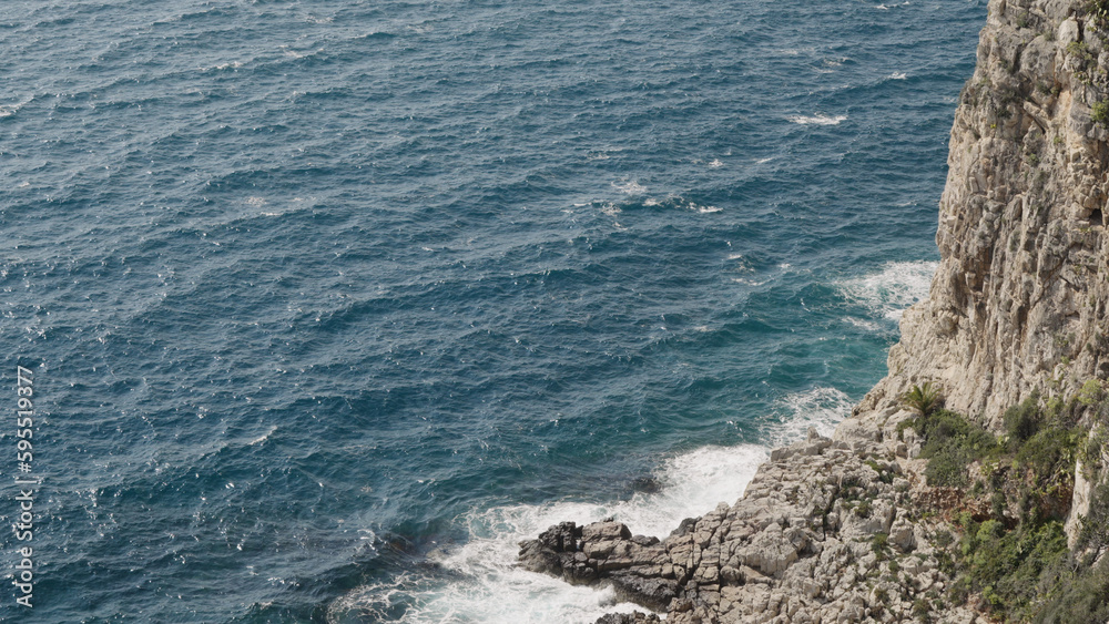 Azure waves of mediterranean sea splashing on French Riviera coast