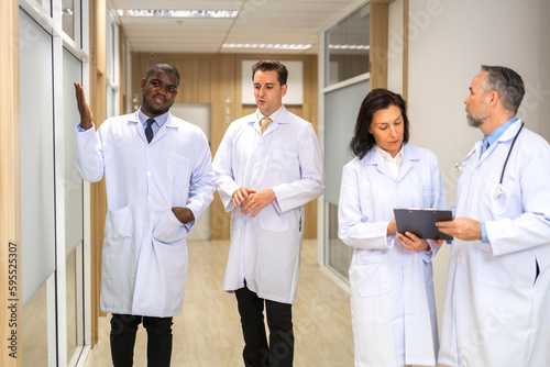 Group of professional medical doctor team meeting training medical in uniform working discussing and talk with patients record  teaching medic team  walk in hospital.health medical care concept