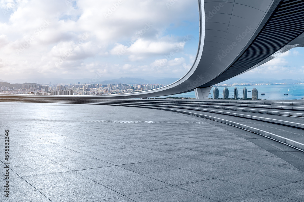 Naklejka premium Empty square floor and bridge with city skyline in Sanya, Hainan, China.