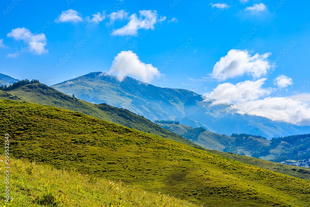 Green grassland and mountain natural scenery in Xinjiang, China. Green grassland and mountain natural scenery in Xinjiang, China.