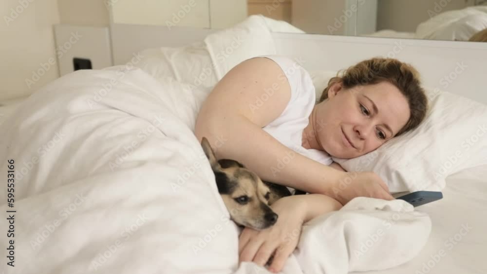 woman in bed with dog phone, pet shop online, online banking, online shopping woman in bed with dog phone, pet shop online, online banking, online shopping