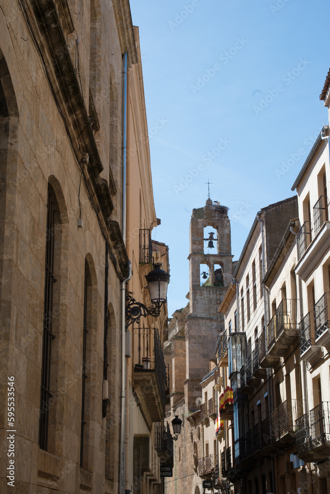 Narrow old street in Ciudad Rodrigo with bell tower.