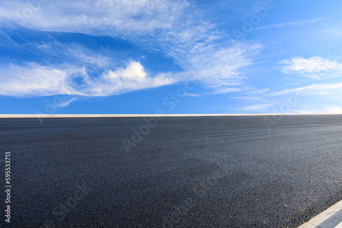Asphalt road and sky clouds background © ABCDstock