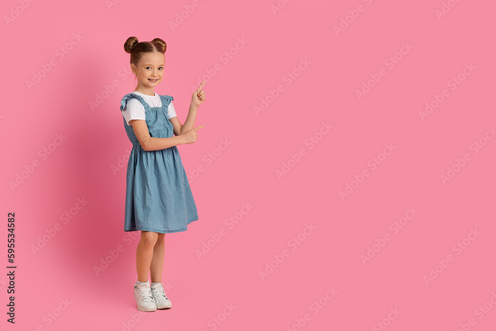Beautiful Little Girl Pointing Aside At Copy Space With Hand,