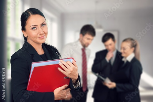 Cheerful young happy business woman in office