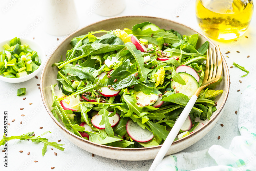 Green salad with spinach, arugula, radish with olive oil and seeds. Green salad with spinach, arugula, radish with olive oil and seeds.