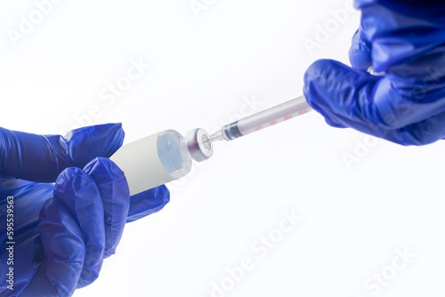 Vaccination concept. Doctor's hand in blue gloves hold medicine vaccine vial bottle and syringe. coronavirus vaccine. Health and medical concepts