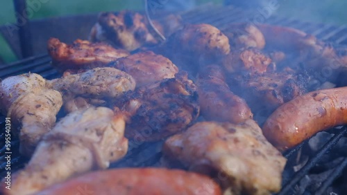 The beginning of the barbecue season. Cooking chicken wings on the grill.