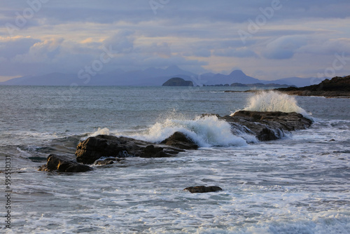 Crashing waves at Duntulm Beach Isle of Skye with the outer Hebrides in the distance. Scotland, UK.