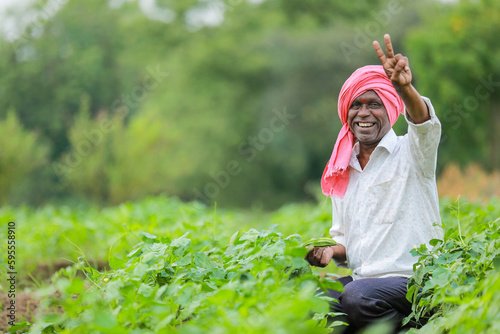 Indian farmer holding tomato in hands, happy farmer