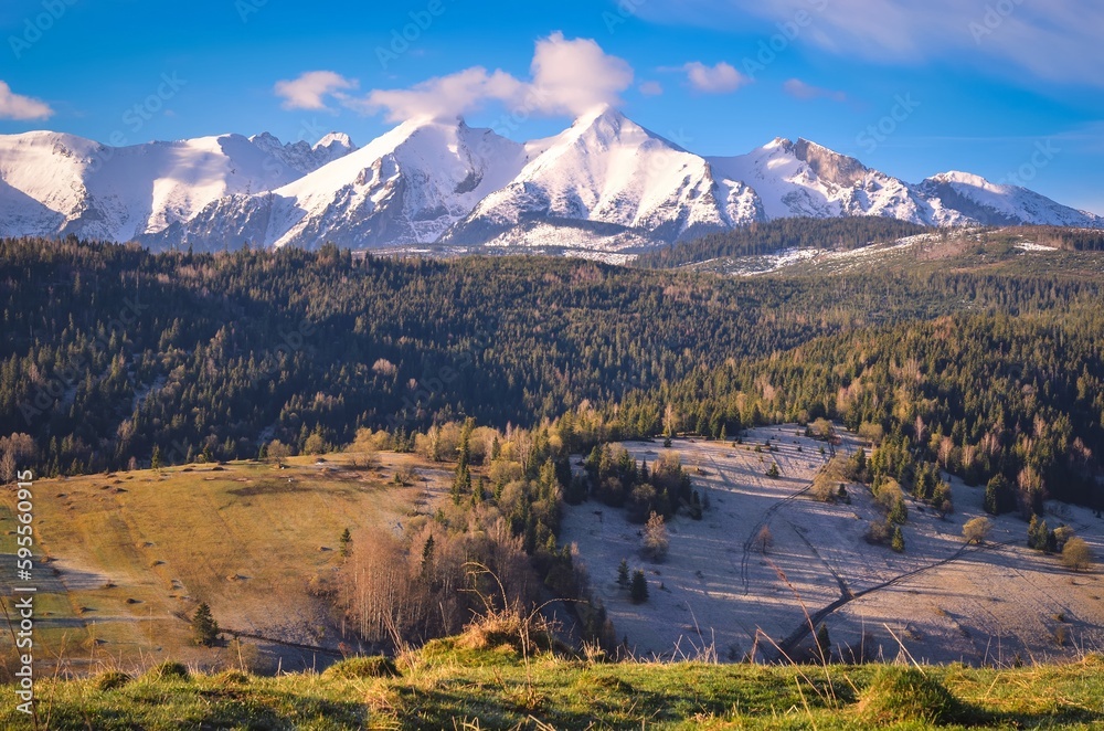 Beautiful morning spring landscape in the countryside. View of the Belianske Tatras from the village of Osturna in Slovakia.