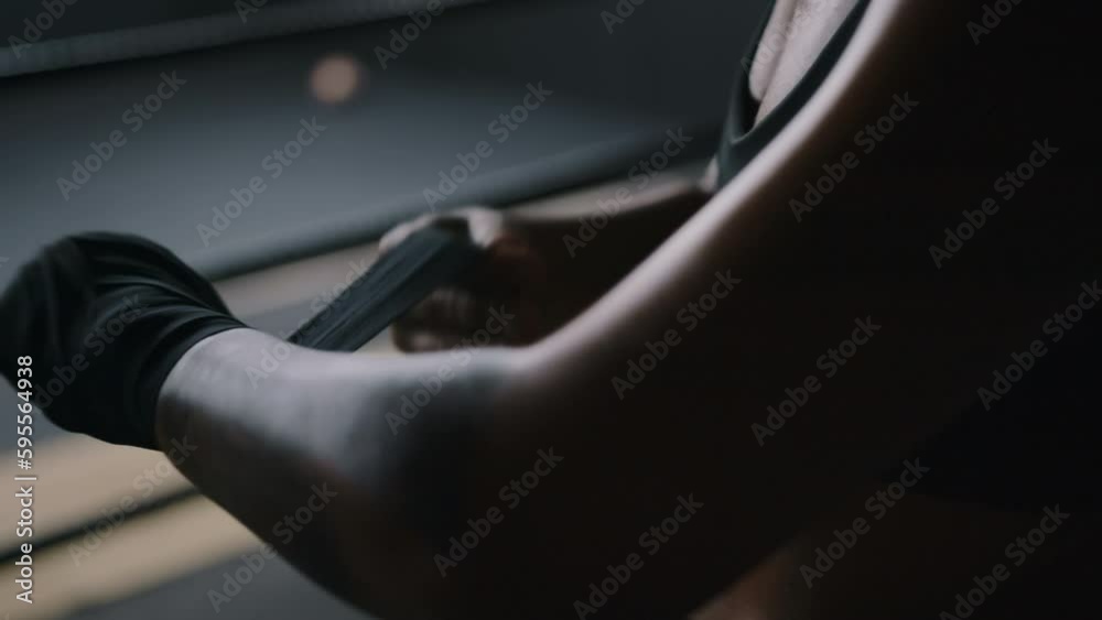 Woman fighter wraps hands wrists with boxing bandage before the fight