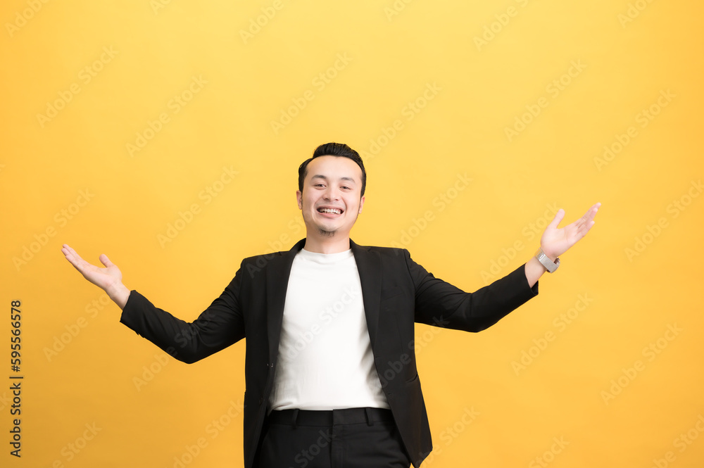 Handsome young man wearing formula, happy, good mood standing on yellow background Handsome young man wearing formula, happy, good mood standing on yellow background