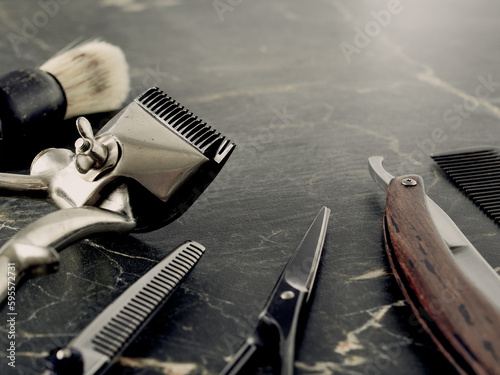 On a grey marble surface are old barber tools