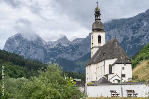 Old traditional church in alpine environment with mountains in background, Hintersee, Germany