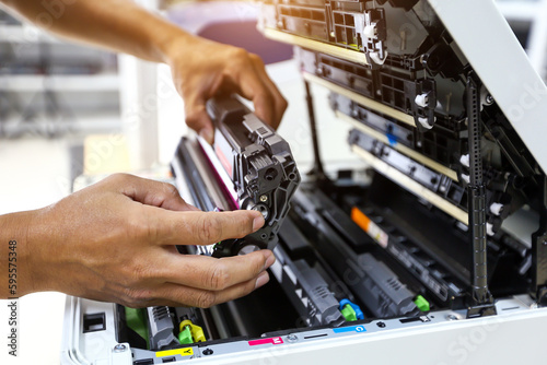 Technician hand open cover printer photocopier or photocopy to replace ink cartridges or fix paper jam for scanning fax or copy document in office workplace.