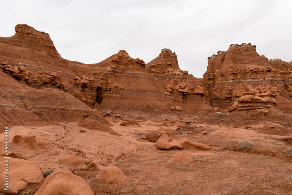 Scenic view on unique eroded sandstone hoodoo rock formations at Goblin Valley State Park, Utah, USA, America. Orange rocks called goblins which are mushroom-shaped rock pinnacles. Canyon hike trail Scenic view on unique eroded sandstone hoodoo rock formations at Goblin Valley State Park, Utah, USA, America. Orange rocks called goblins which are mushroom-shaped rock pinnacles. Canyon hike trail