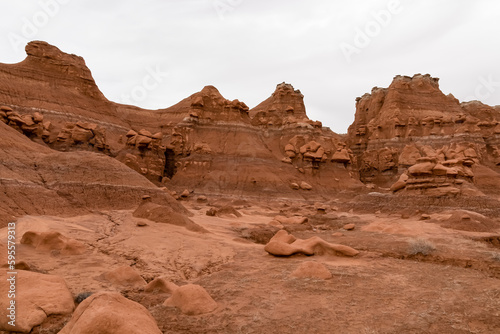 Scenic view on unique eroded sandstone hoodoo rock formations at Goblin Valley State Park, Utah, USA, America. Orange rocks called goblins which are mushroom-shaped rock pinnacles. Canyon hike trail