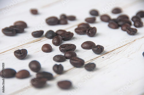 Scattered coffee beans on wooden cover background with customizable space for text or coffee ideas photo