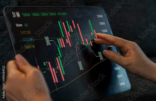 Successful of trader use tablet computer trading stock exchange graph, money, block chain, stock market, cryptocurrency, selling and buy with price chart data graph, business, financial, funds