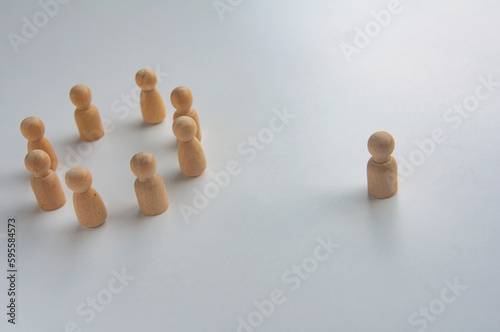 A wooden figure isolated from the rest of the wooden figures photo