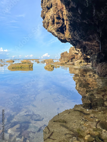 the rocks on the edge of the beach of Sawarna, Indonesia, the sea, the view under the beach, the view of the sky above the beach