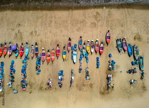Aerial shot from a drone of a group of local fishing boats at Jomtien Beach, Pattaya, Thailand.