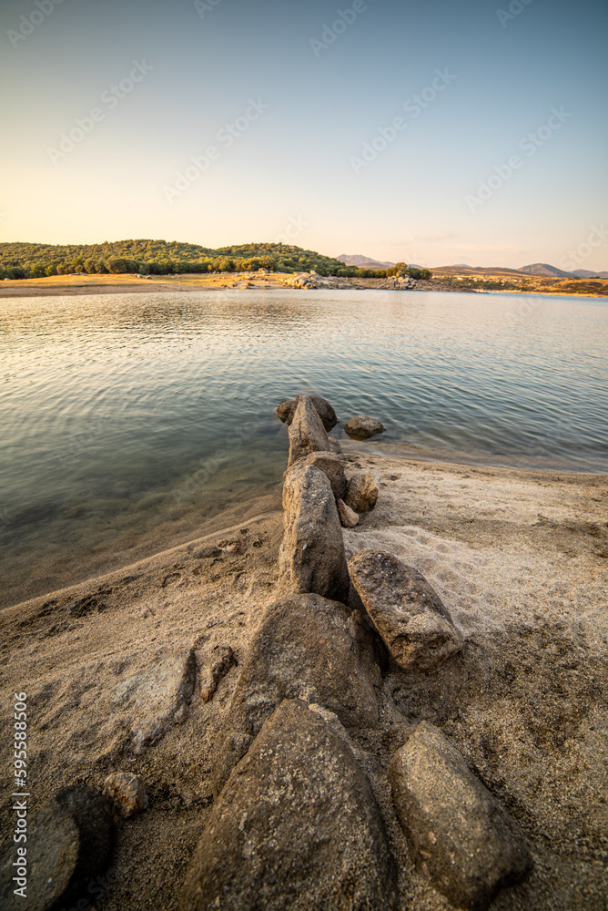 Reservoir, mysterious waters paint the dawn of a summer night