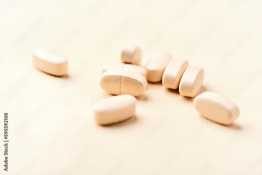 Vitamin C tablets on bright paper background. Soft focus. Close up. Copy space. Vitamin C tablets on bright paper background. Soft focus. Close up. Copy space.