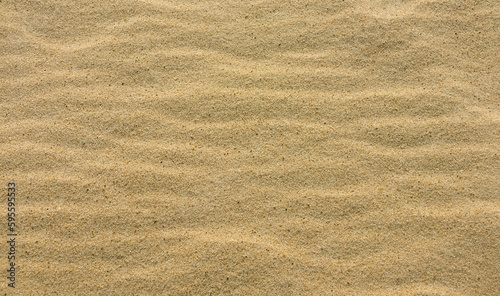 Quartz yellow sand close up. Natural background, top view. Sandy surface