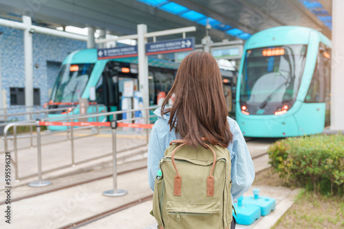 woman traveler visiting in Taiwan, happy Tourist traveling in Light Rail System near Tamsui District Taipei city, landmark and popular attractions. Asia Travel,  vacation and Trip concept photo