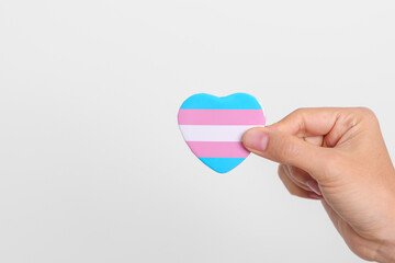 Transgender Day and LGBT pride month,  LGBTQ+ or LGBTQIA+ concept. hand holding blue, pink and white heart shape for Lesbian, Gay, Bisexual, Transgender, Queer and Pansexual community