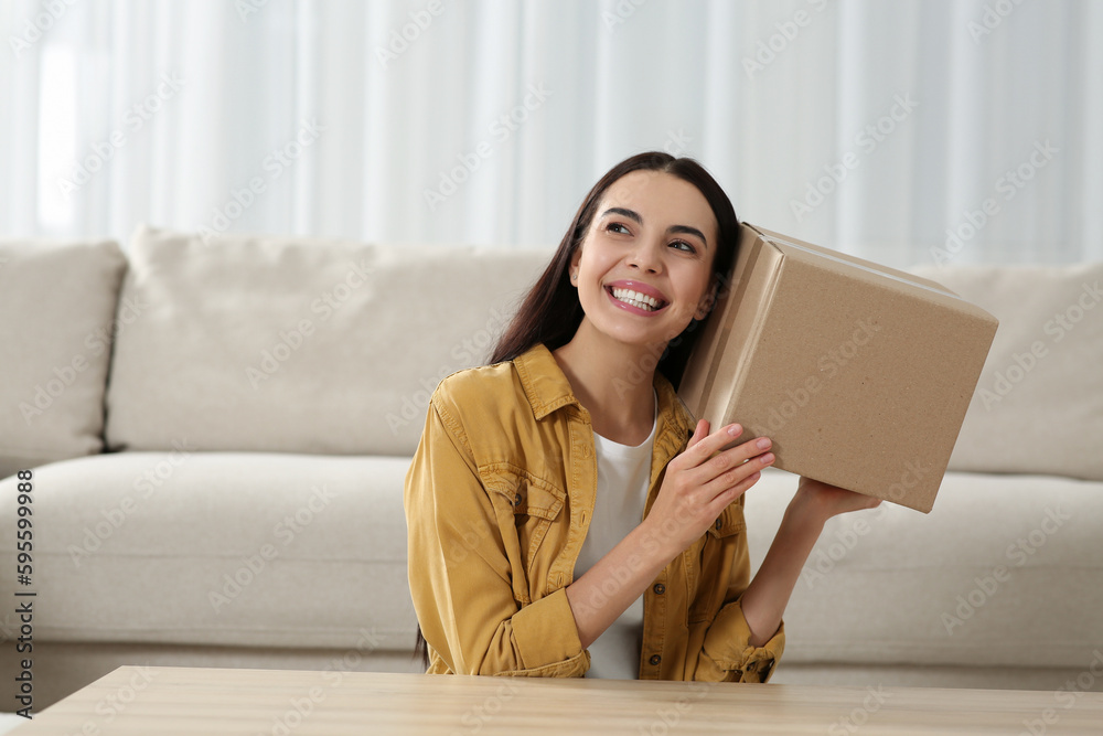 Happy young woman with parcel at home. Internet shopping Happy young woman with parcel at home. Internet shopping