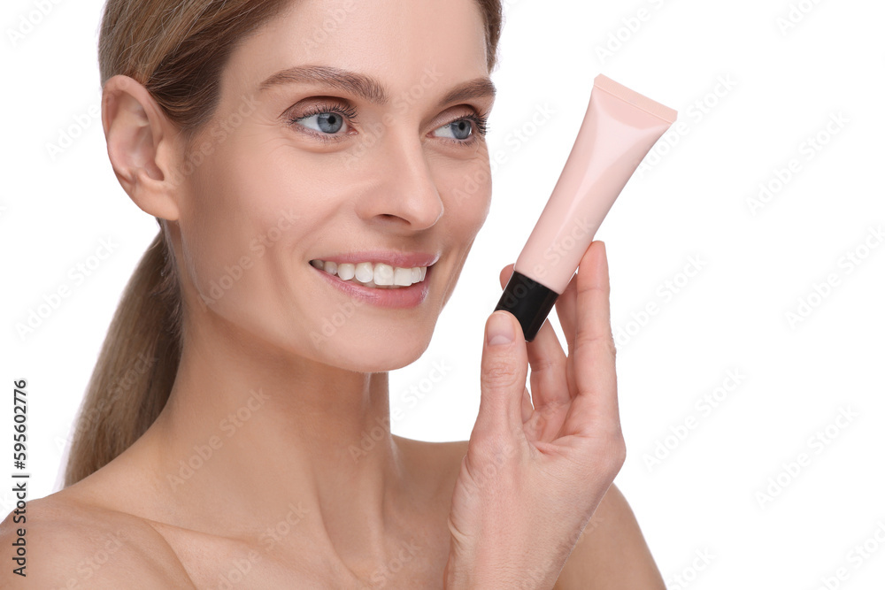 Woman holding tube with foundation on white background Woman holding tube with foundation on white background