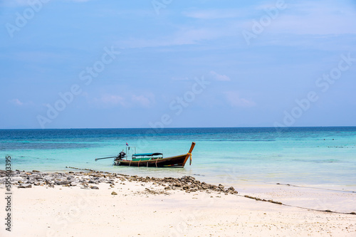 Long tailed boats near tropical beach at Ko Phi Phi, Thailand. Tropic beach with white sand and turquoise water, concept of vacation in paradise. © Martin