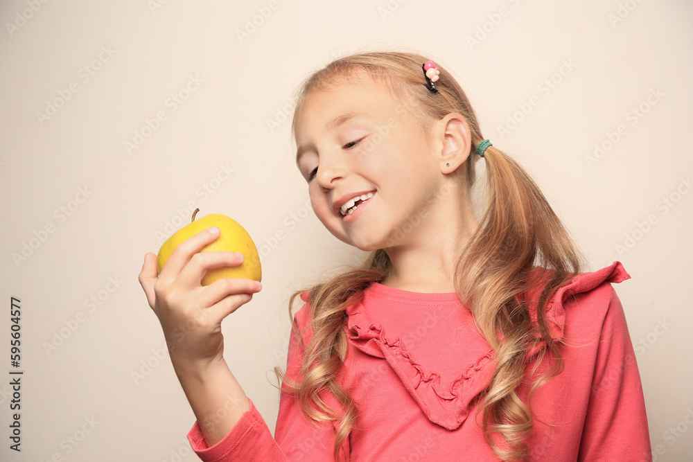 Cute little girl with apple on light background Cute little girl with apple on light background