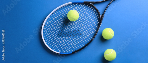 Tennis racket and balls on blue background, flat lay. Banner design © New Africa