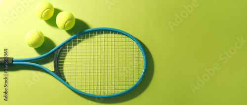 Tennis racket and balls on green background, flat lay. Banner design with space for text © New Africa