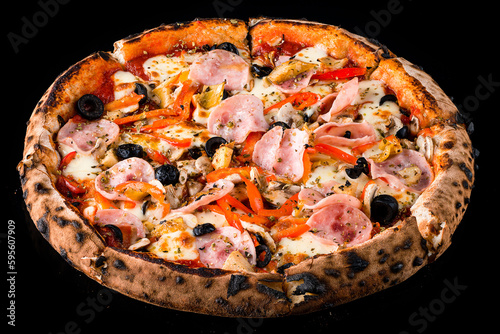 Italian food pizza with ham, cheese, mushrooms, onions, olives, sweet peppers, tomato sauce and spices isolated on black.