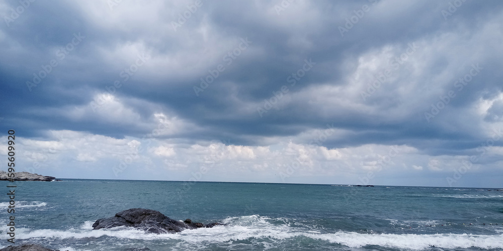 Stormy sky over the sea. Panoramic view of stormy sea.