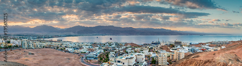 Panorama. Morning aerial view on the Red Sea. Scenic landscape with surrounding mountains and buildings of Eilat (Israel) and Aqaba (Jordan) cities. 