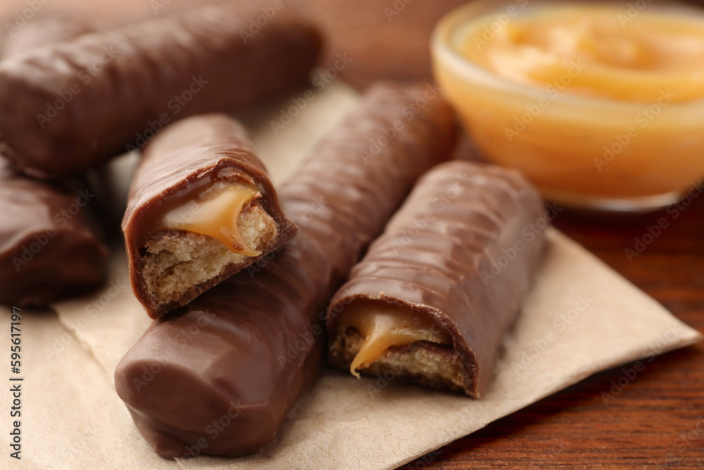 Sweet tasty chocolate bars with caramel on wooden table Sweet tasty chocolate bars with caramel on wooden table