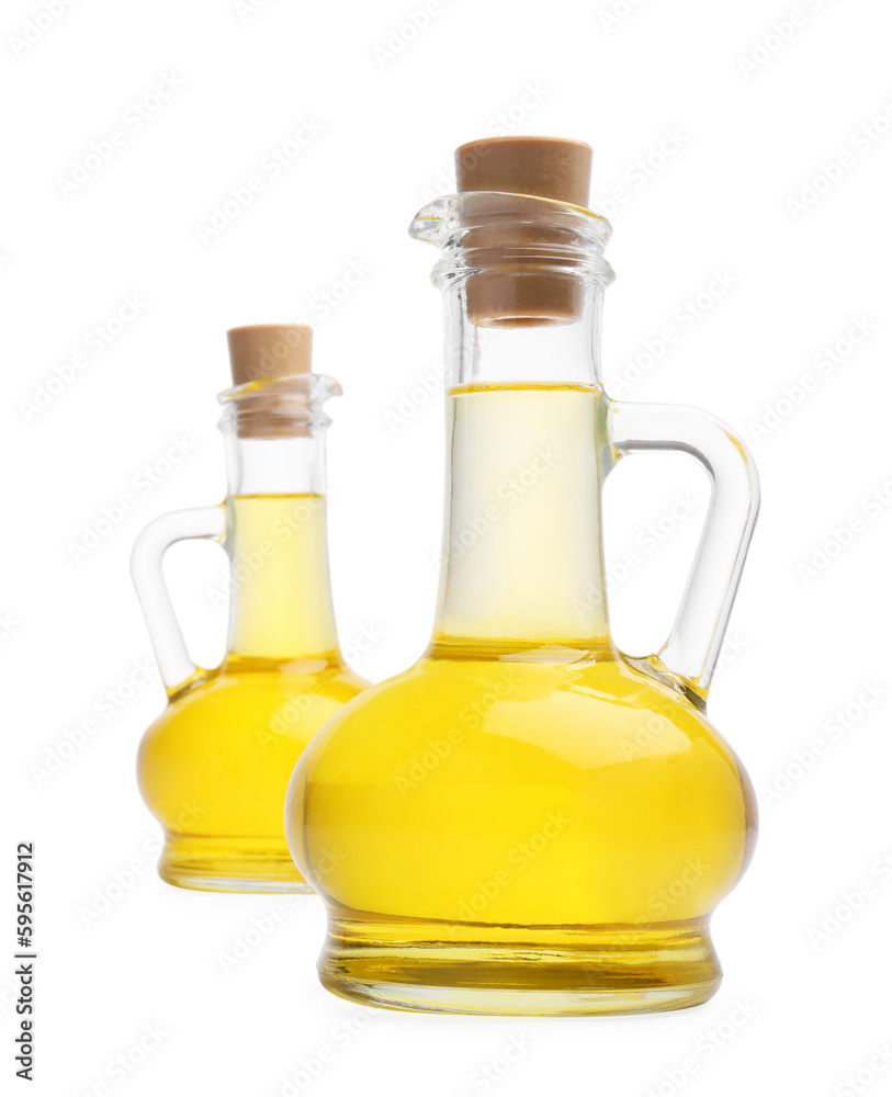 Glass jugs of cooking oil on white background Glass jugs of cooking oil on white background