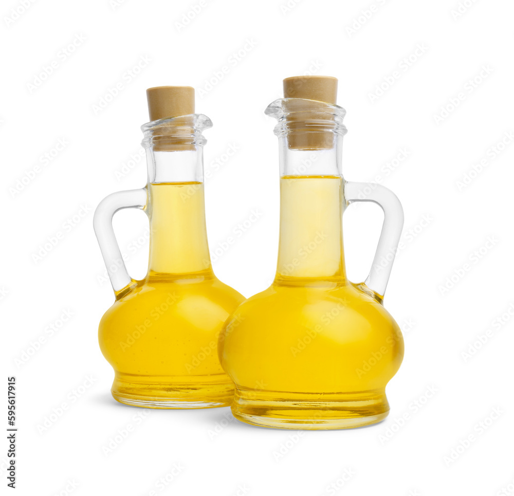 Glass jugs of cooking oil on white background Glass jugs of cooking oil on white background