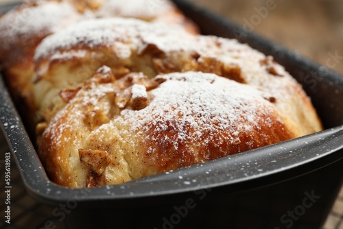 Delicious yeast dough cake in baking pan, closeup