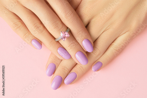 Womans hands with fashionable lavender manicure. Spring summer nail design